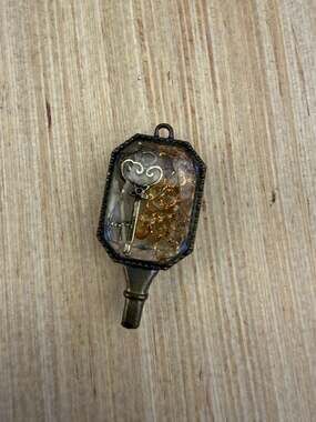 vintage or antique-style watch key pendant,